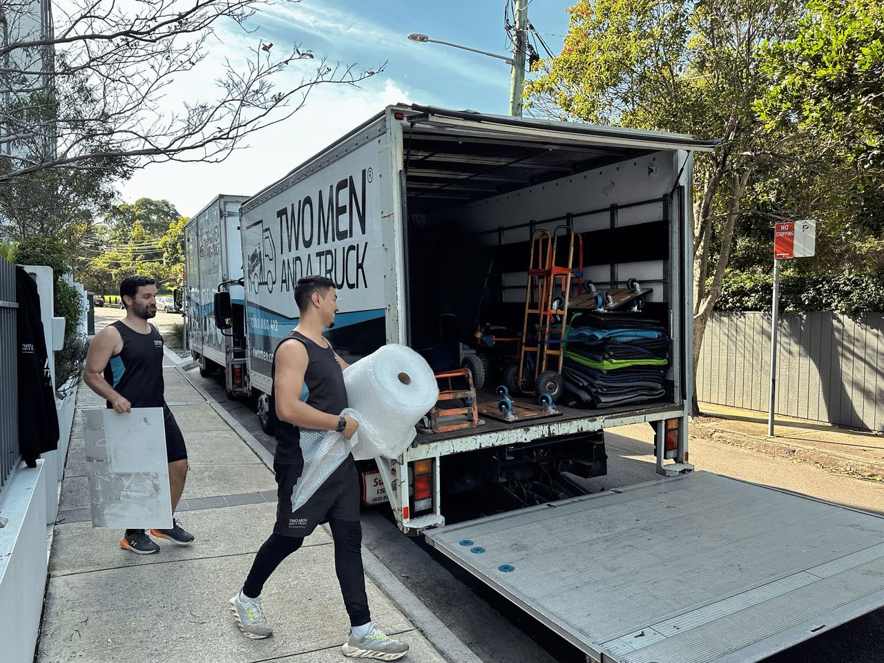Removalist carrying boxes on moving day in Australia – moving home checklist guide