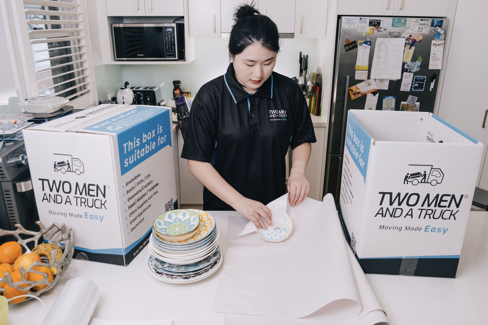 Moving home checklist Australia – packing boxes and planning tools laid out on a table